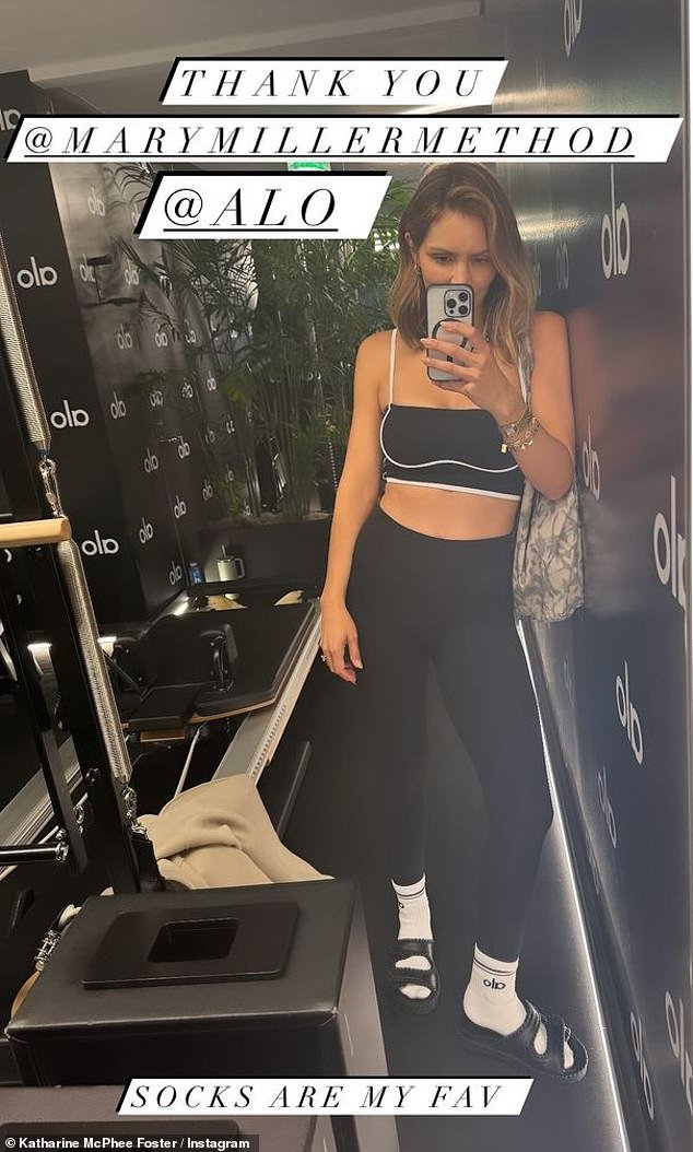 Katharine McPhee shows off her toned stomach in a black sports bra and leggings while doing pilates.